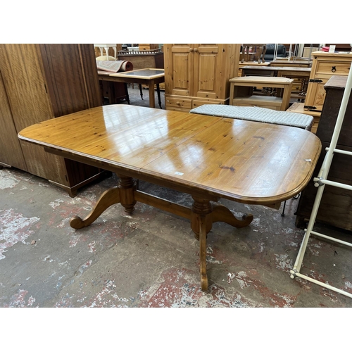 36 - A pine twin pedestal extending dining table - approx. 76cm high x 100cm wide x 180cm long