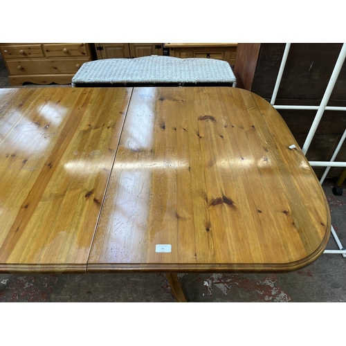 36 - A pine twin pedestal extending dining table - approx. 76cm high x 100cm wide x 180cm long