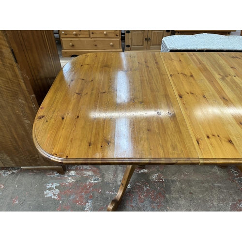 36 - A pine twin pedestal extending dining table - approx. 76cm high x 100cm wide x 180cm long