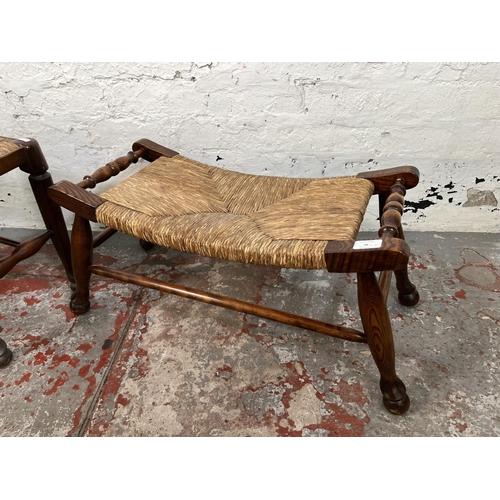 38 - Two 19th century style elm and rush seated stools - largest approx. 33cm high x 30cm wide x 66cm lon... 