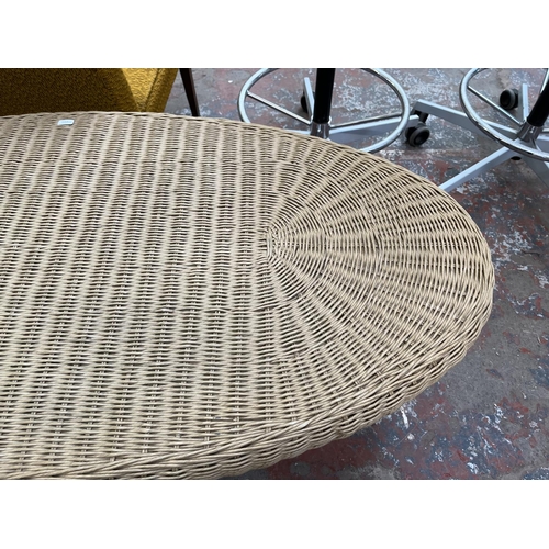 47 - A wicker and mindy ash oval coffee table - approx. 47cm high x 60cm wide x 120cm long