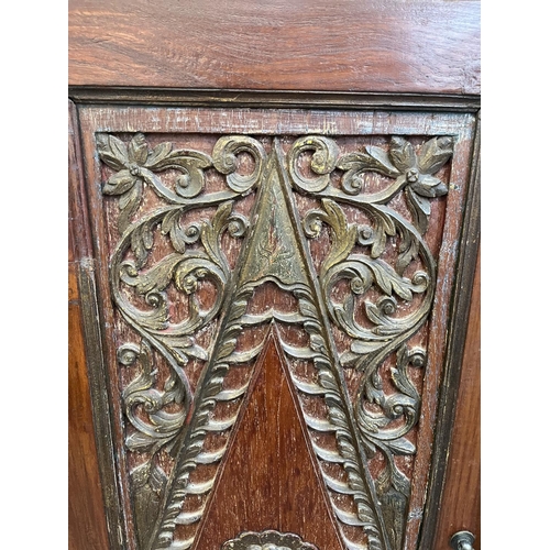 49 - An Indonesian carved teak two door cabinet - approx. 166cm high x 114cm wide x 49cm deep