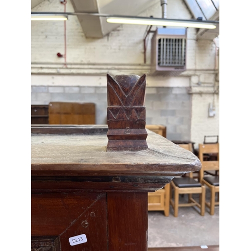 49 - An Indonesian carved teak two door cabinet - approx. 166cm high x 114cm wide x 49cm deep