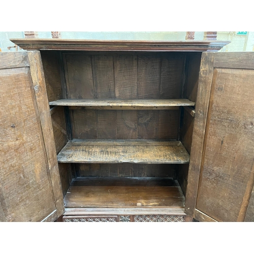 49 - An Indonesian carved teak two door cabinet - approx. 166cm high x 114cm wide x 49cm deep