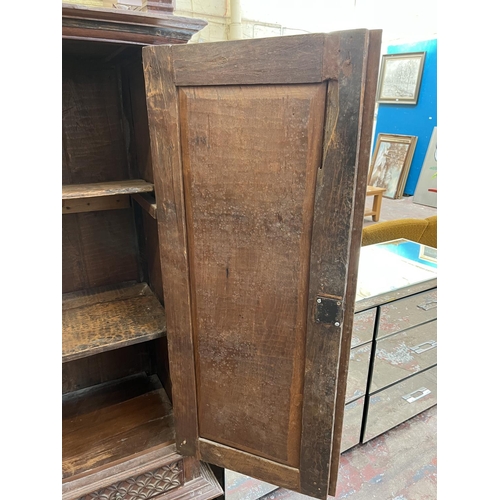 49 - An Indonesian carved teak two door cabinet - approx. 166cm high x 114cm wide x 49cm deep