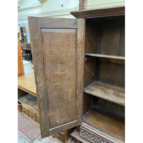 49 - An Indonesian carved teak two door cabinet - approx. 166cm high x 114cm wide x 49cm deep