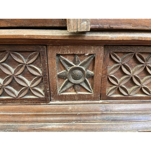 49 - An Indonesian carved teak two door cabinet - approx. 166cm high x 114cm wide x 49cm deep