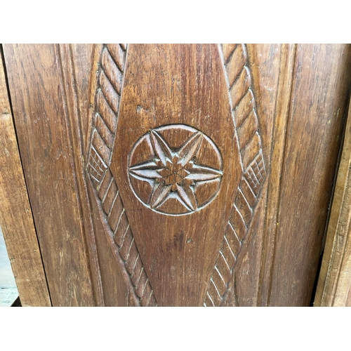 51 - An Indonesian carved teak two door cabinet - approx. 140cm high x 89cm wide x 35cm deep