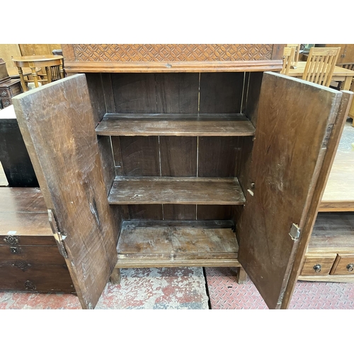 51 - An Indonesian carved teak two door cabinet - approx. 140cm high x 89cm wide x 35cm deep