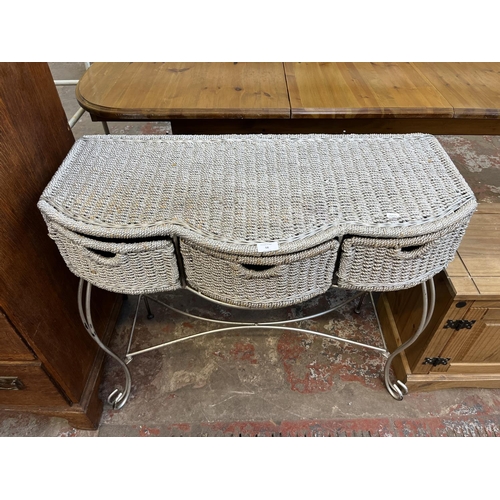 58 - A modern silver painted wicker and wrought metal three drawer console table - approx. 75cm high x 91... 