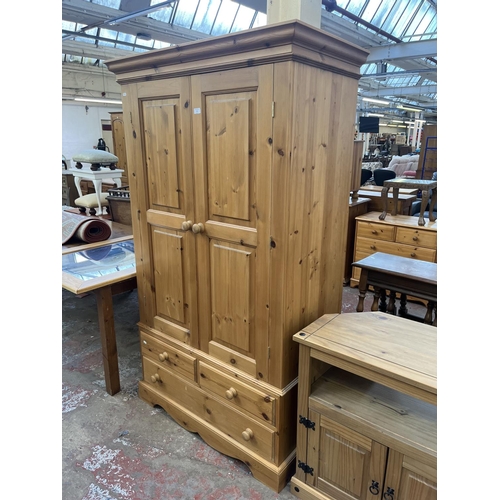 64 - A solid pine double wardrobe - approx. 188cm high x 109cm wide x 58cm deep