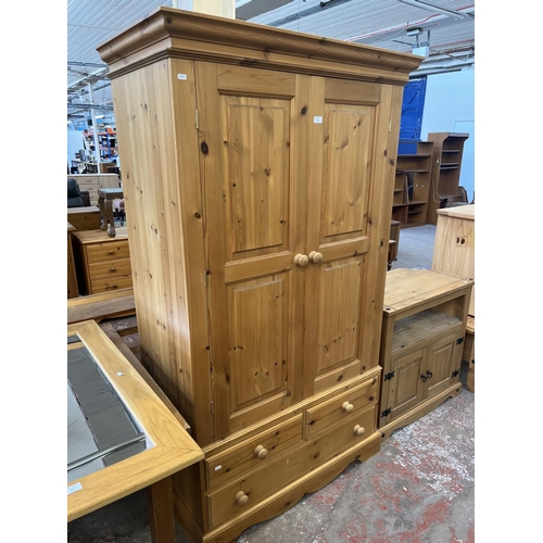 64 - A solid pine double wardrobe - approx. 188cm high x 109cm wide x 58cm deep