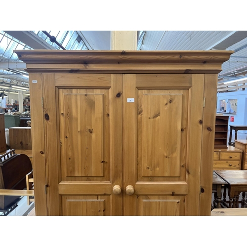 64 - A solid pine double wardrobe - approx. 188cm high x 109cm wide x 58cm deep