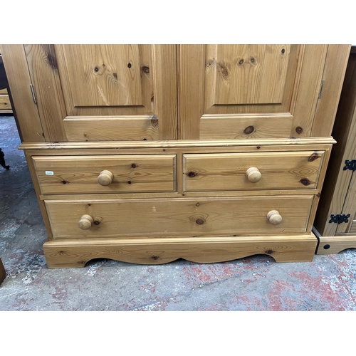 64 - A solid pine double wardrobe - approx. 188cm high x 109cm wide x 58cm deep