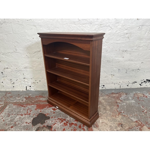 83 - A mahogany four tier wall mountable bookshelf - approx. 63cm high x 49cm wide x 13cm deep