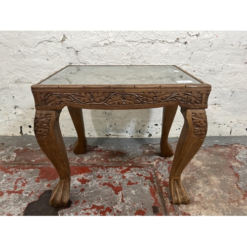 87 - An Indian carved teak side table with glass insert - approx. 38cm high x 41cm wide x 31cm deep