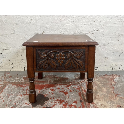 98 - A 17th century style carved oak sewing box with grapevine design - approx. 47cm high x 49cm wide x 3... 