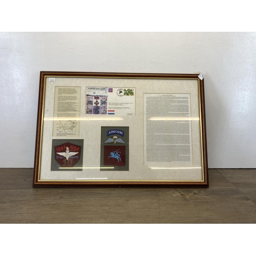 481 - A framed Battle of Arnhem memorial presentation board with 1944-1994 cloth patch, first day cover et... 