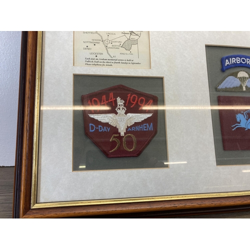 481 - A framed Battle of Arnhem memorial presentation board with 1944-1994 cloth patch, first day cover et... 