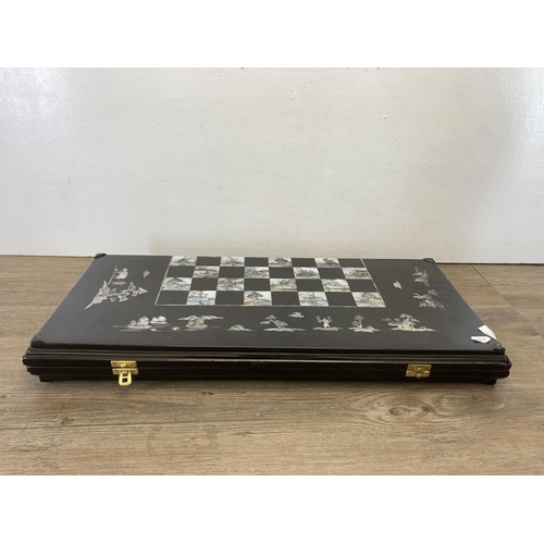 517 - A vintage Japanese black lacquered and mother of pearl inlaid folding travelling chess board - appro... 