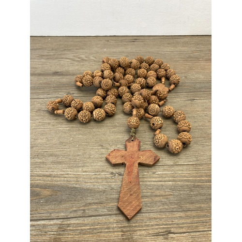 521 - A collection of items to include vintage carved wooden rosary beads, pair of carved alabaster horse ... 