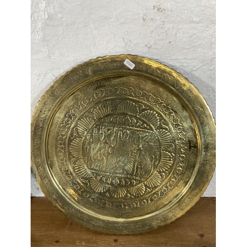 293 - Five vintage Middle Eastern brass serving trays - largest approx. 62cm diameter