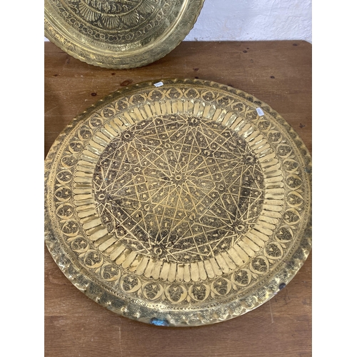 293 - Five vintage Middle Eastern brass serving trays - largest approx. 62cm diameter