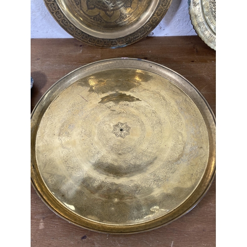 293 - Five vintage Middle Eastern brass serving trays - largest approx. 62cm diameter