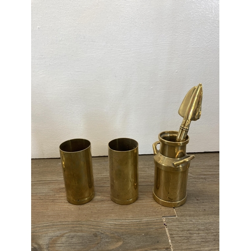 296 - A collection of metalware to include two pairs of brass candlesticks, brass chamber stick, brass lad... 