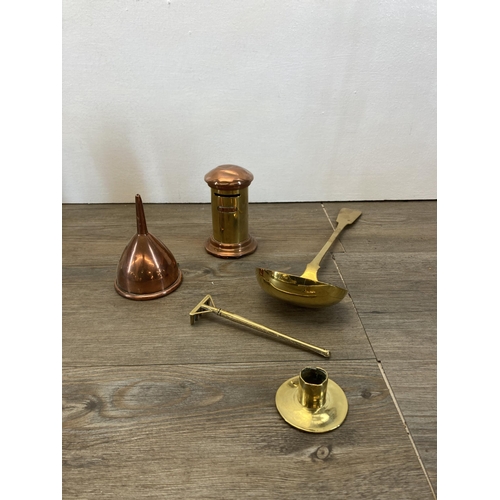 296 - A collection of metalware to include two pairs of brass candlesticks, brass chamber stick, brass lad... 