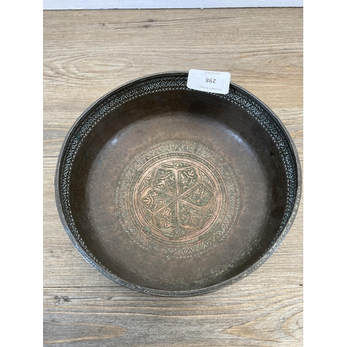 298 - An antique Middle Eastern engraved copper footed bowl - approx. 9.5cm high x 19cm diameter