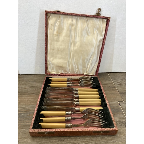 305 - Three vintage cased cutlery sets