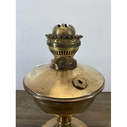 306 - A 19th century brass oil lamp - approx. 33cm high