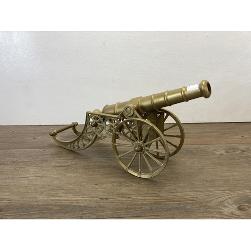 313 - A vintage brass cannon model - approx. 22cm high x 11cm wide x 36cm long