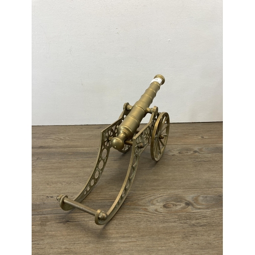 313 - A vintage brass cannon model - approx. 22cm high x 11cm wide x 36cm long