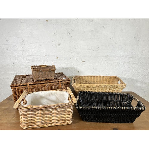 123 - Seven items, six wicker baskets and one vintage brown leather travel case