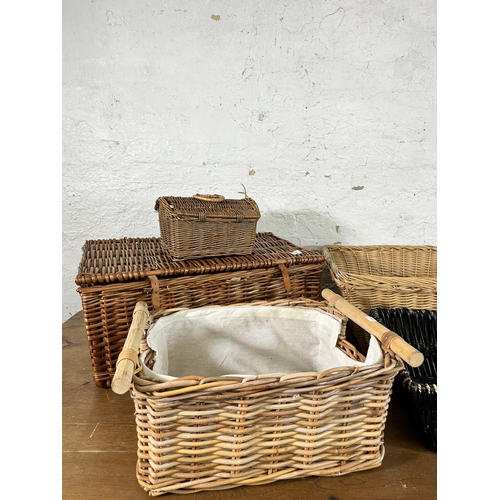 123 - Seven items, six wicker baskets and one vintage brown leather travel case