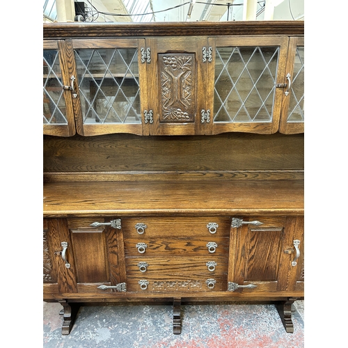 125 - A carved oak dresser - approx. 162cm high x 187cm wide x 43cm deep