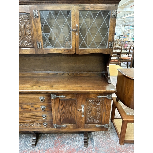 125 - A carved oak dresser - approx. 162cm high x 187cm wide x 43cm deep