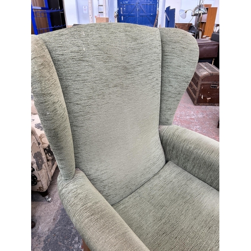 133 - A HSL green fabric and beech wingback armchair