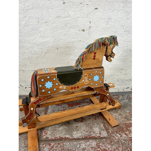 134 - A 1980s hand painted wooden rocking horse on pine stand - approx. 94cm high x 58cm wide x 147cm long