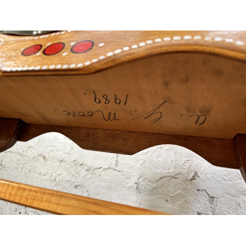 134 - A 1980s hand painted wooden rocking horse on pine stand - approx. 94cm high x 58cm wide x 147cm long