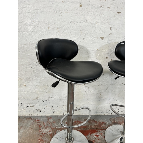 136 - A pair of modern black leatherette and chrome plated kitchen bar stools