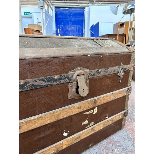 137 - An early 20th century wooden banded canvas dome top travel trunk - approx. 53cm high x 69cm wide x 4... 