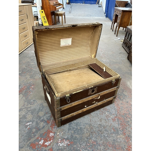 137 - An early 20th century wooden banded canvas dome top travel trunk - approx. 53cm high x 69cm wide x 4... 