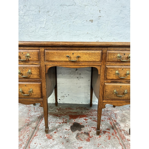 141A - A late 19th/early 20th century oak and green leather writing desk stamped B. Line & Co Birmingham to... 