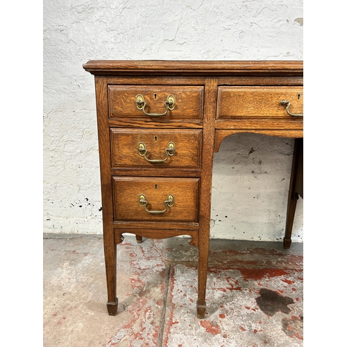 141A - A late 19th/early 20th century oak and green leather writing desk stamped B. Line & Co Birmingham to... 