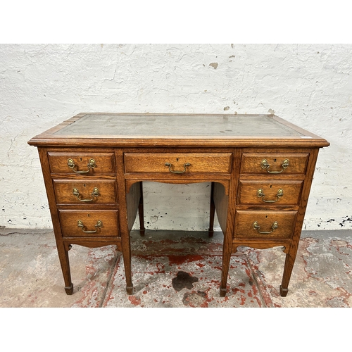 141A - A late 19th/early 20th century oak and green leather writing desk stamped B. Line & Co Birmingham to... 