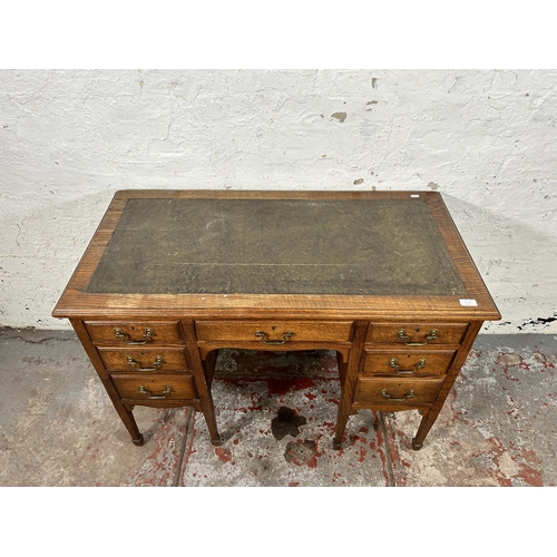 141A - A late 19th/early 20th century oak and green leather writing desk stamped B. Line & Co Birmingham to... 