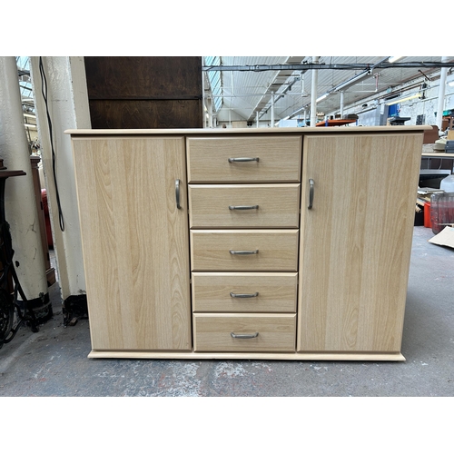 142 - A modern beech effect sideboard - approx. 89cm high x 123cm wide x 42cm deep